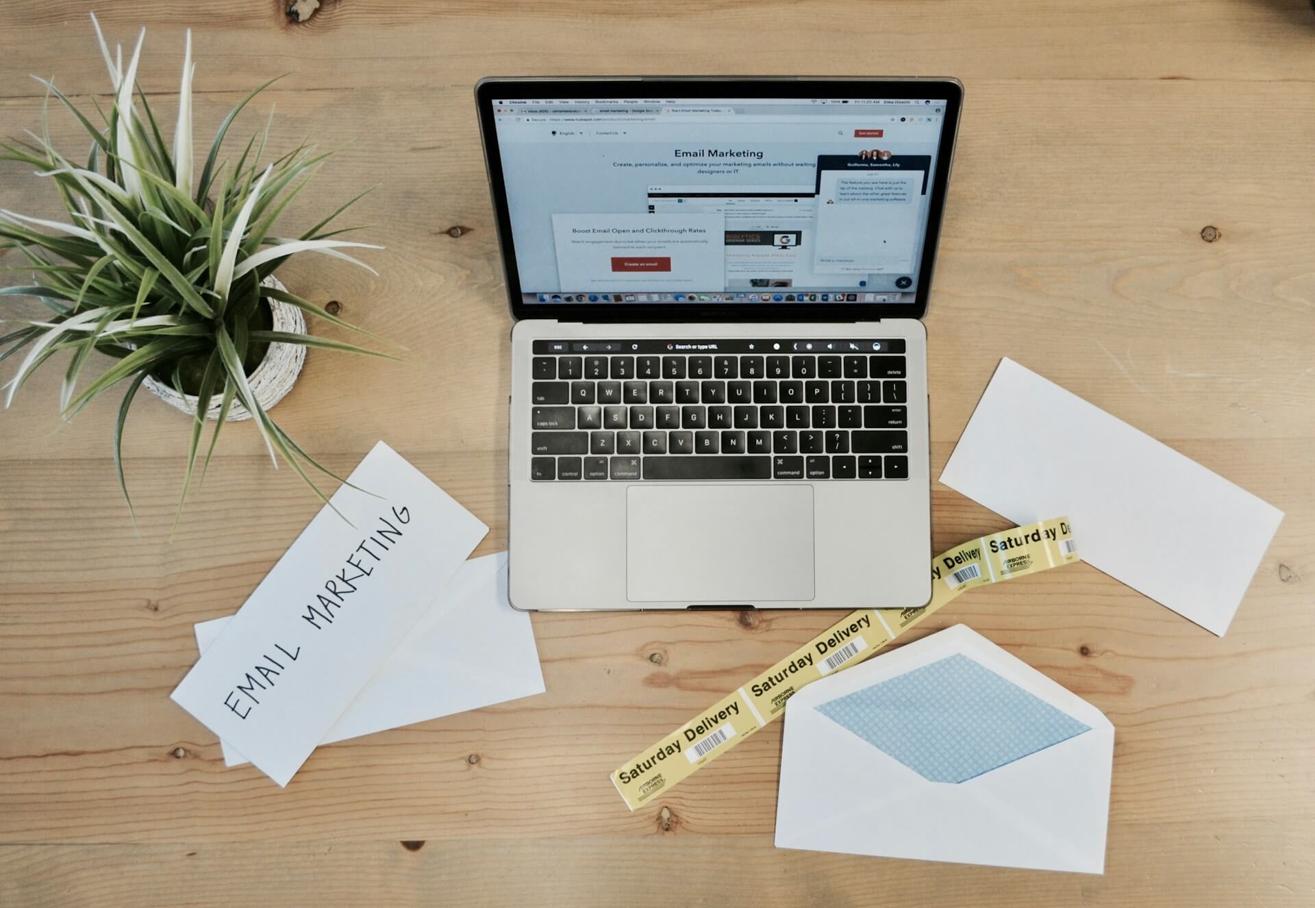Email marketing dashboard on laptop with coffee showing subscriber growth