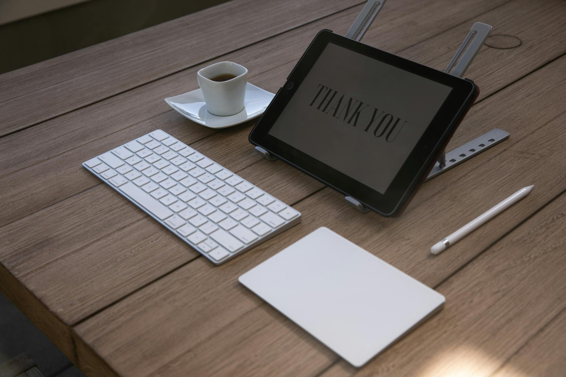 Handwritten thank you note next to a laptop showing an email client